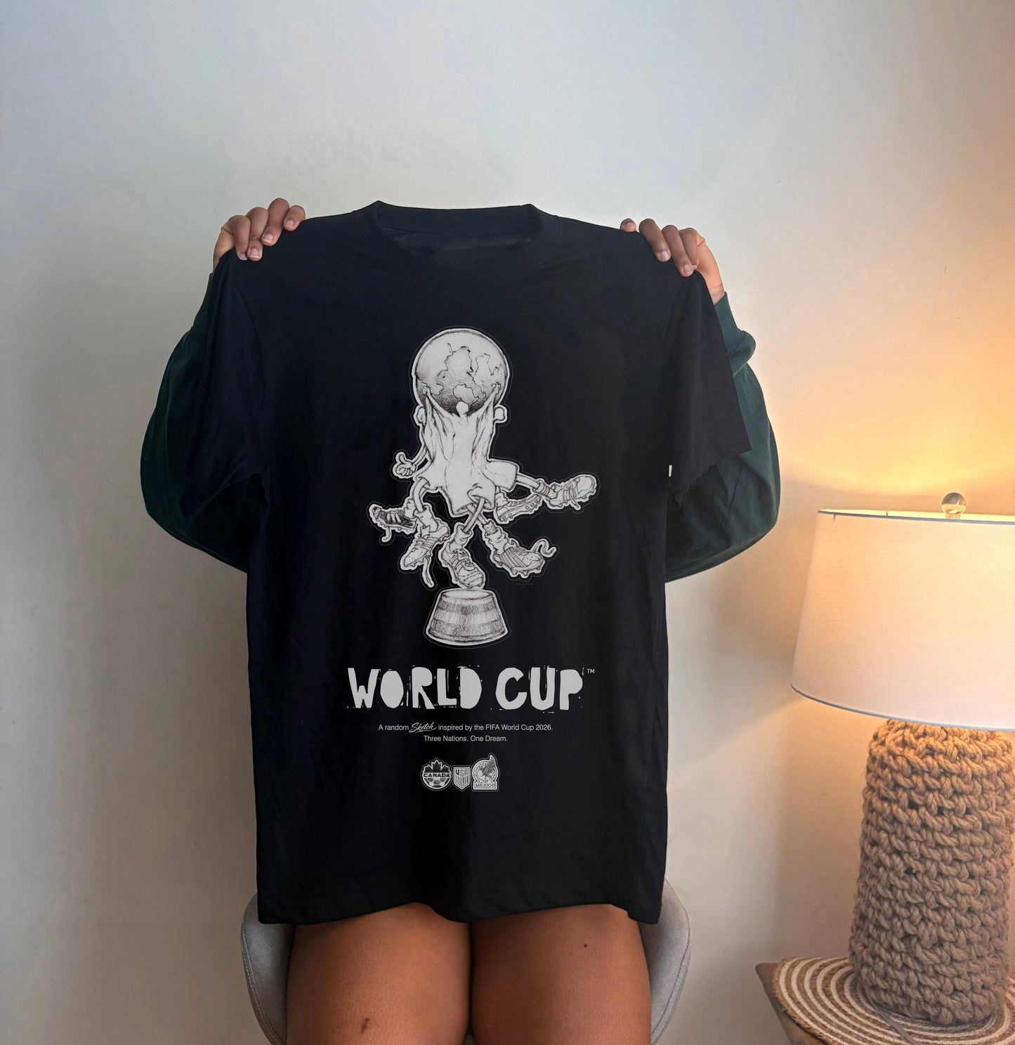 Black 2026 World Cup graphic t-shirt featuring an artistic soccer-inspired illustration for football fans