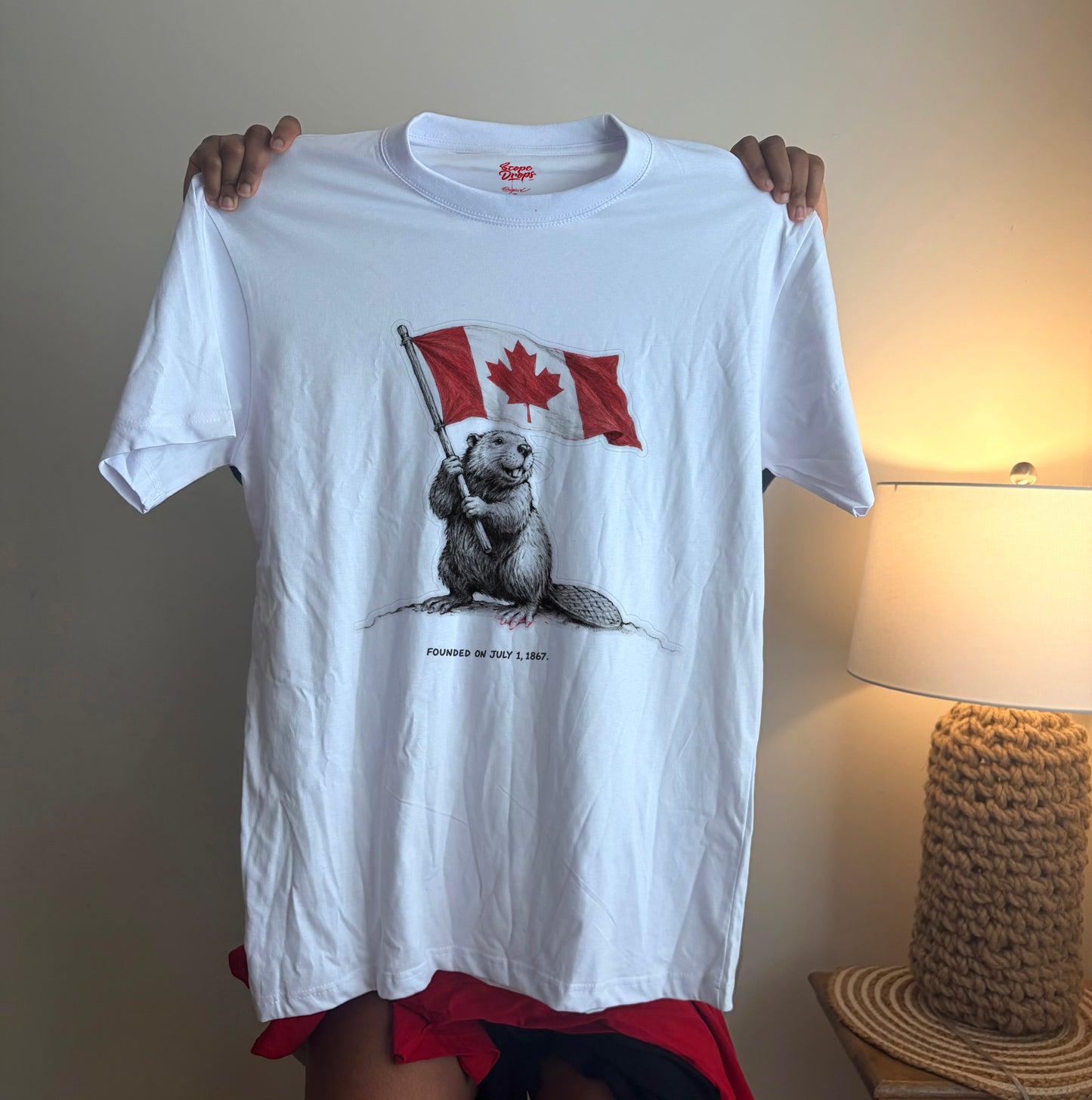 White Canadian Beaver graphic t-shirt featuring a beaver holding the Canadian flag for Canada Day celebrations.