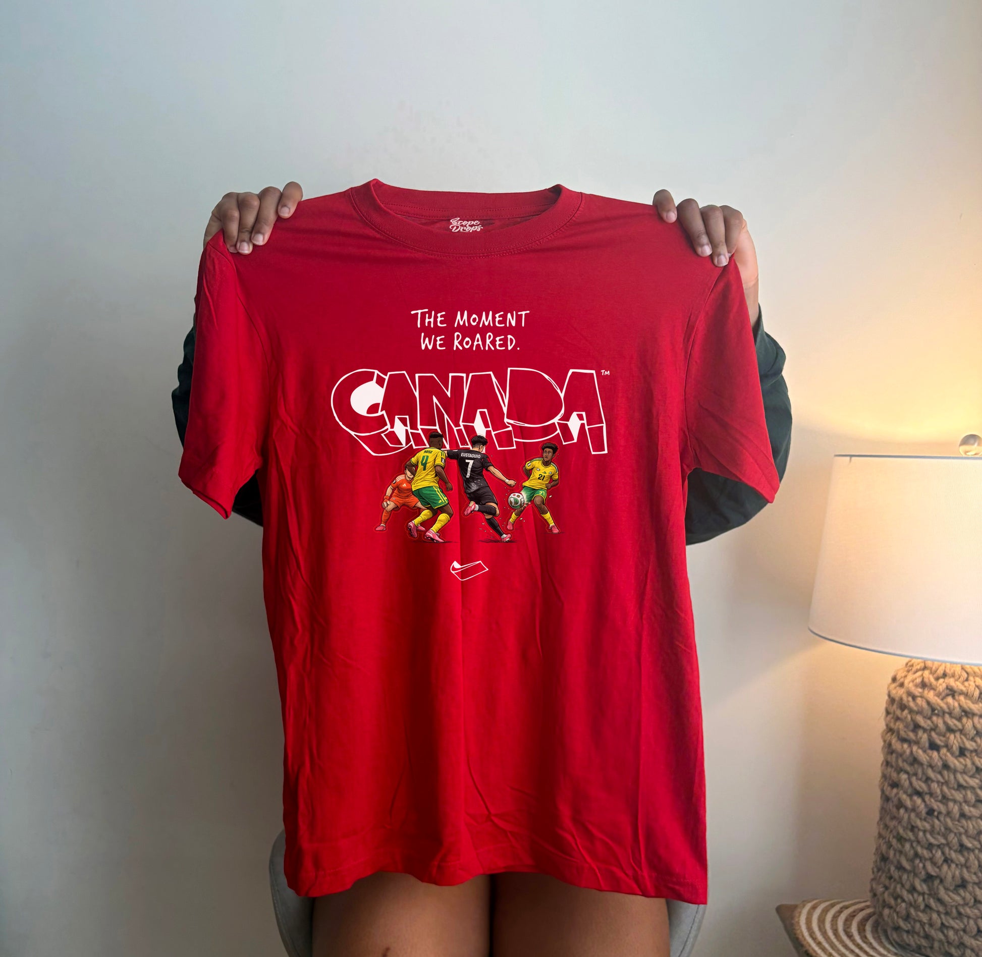 Red Canada Soccer graphic t-shirt featuring The Moment We Roared design for World Cup fans.
